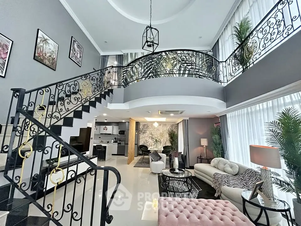 Luxurious open-plan living room with elegant staircase and modern decor