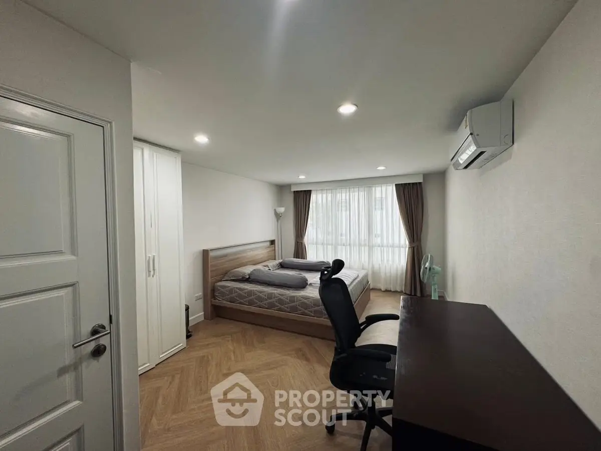 Spacious bedroom with modern furnishings and natural light