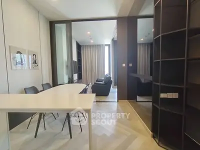 Modern open-plan living and dining area with sleek furniture and natural light.