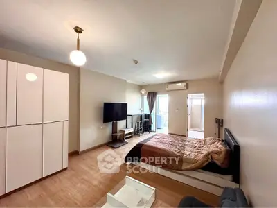 Modern studio apartment with cozy bedroom and balcony access, featuring stylish furniture and ample natural light.