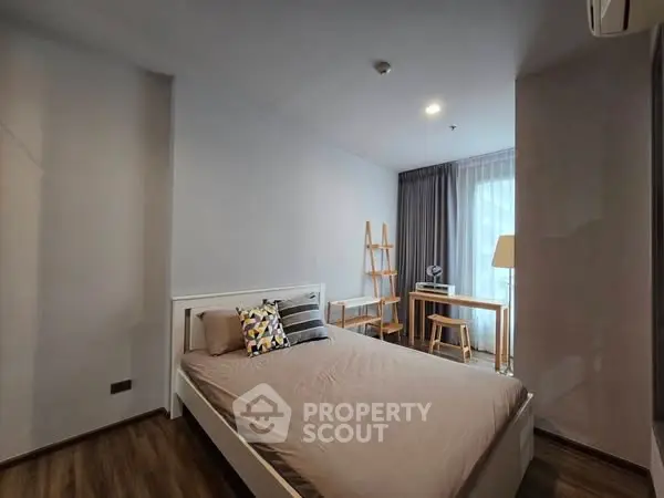 Modern bedroom with stylish decor and natural light, perfect for a cozy retreat.