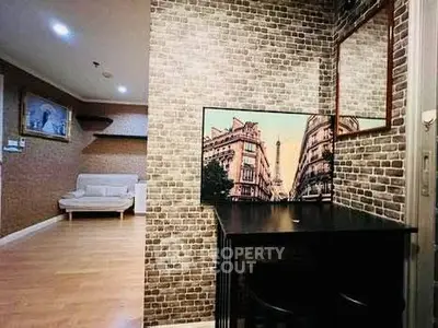 Chic urban apartment with stylish brick accent wall and cozy seating area.