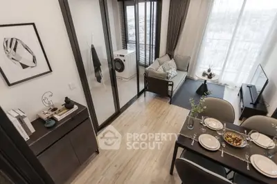 Modern living room with dining area and washing machine, featuring stylish decor and large windows.