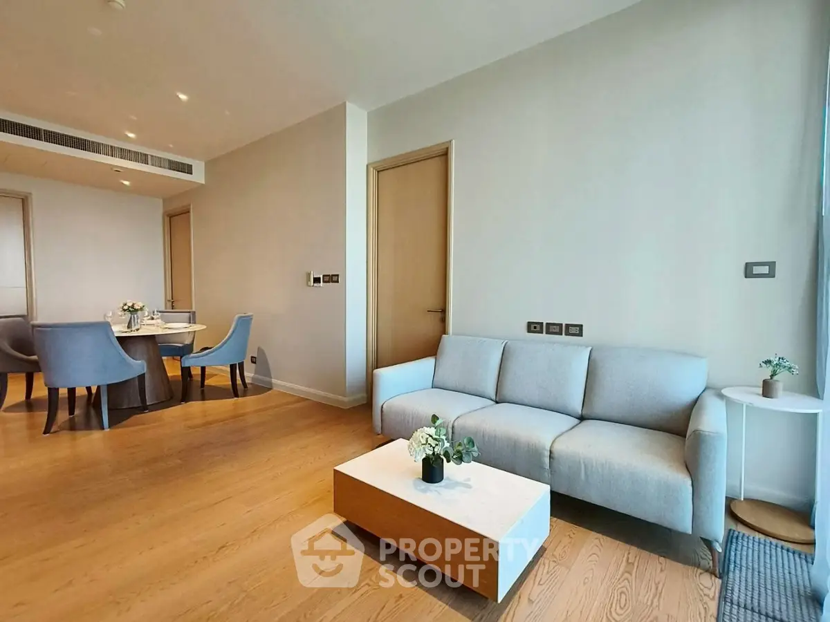 Modern living room with elegant dining area and cozy seating