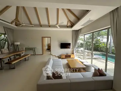 Spacious living room with pool view and modern decor