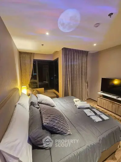 Luxurious bedroom with moonlit ambiance and modern decor, featuring a cozy bed and large TV.