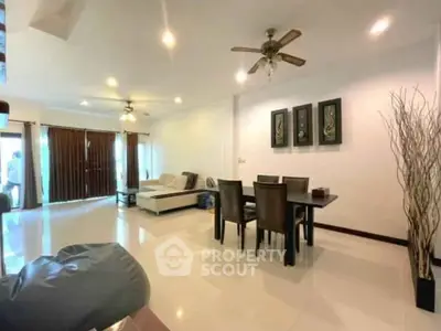 Spacious living room with modern decor and ceiling fan