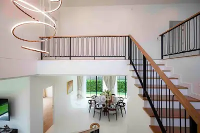 Stunning modern living room with elegant staircase and stylish chandelier