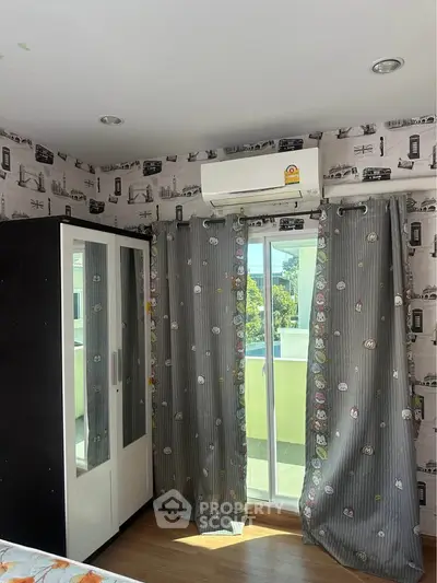 Cozy bedroom with balcony access and stylish wallpaper