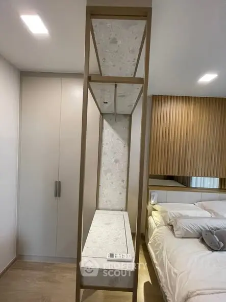 Modern bedroom with stylish decor and built-in storage solutions.