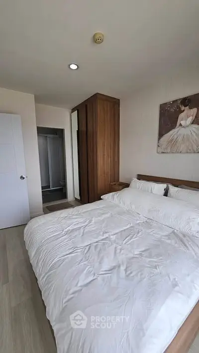 Spacious bedroom with elegant decor and ample natural light