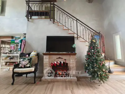 Charming living room with elegant staircase and festive Christmas decor