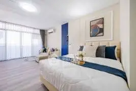 Spacious modern bedroom with stylish decor and natural light