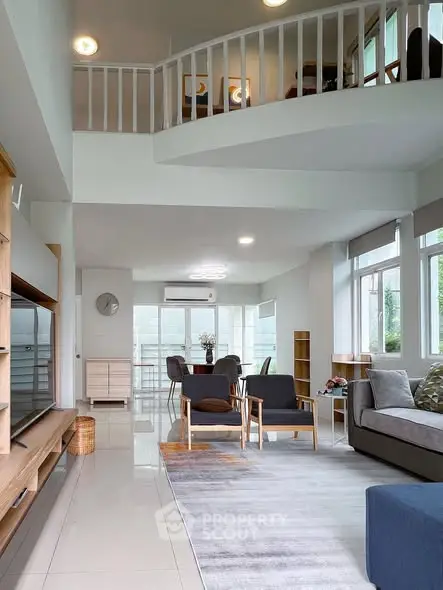 Spacious modern living room with high ceiling and stylish furniture