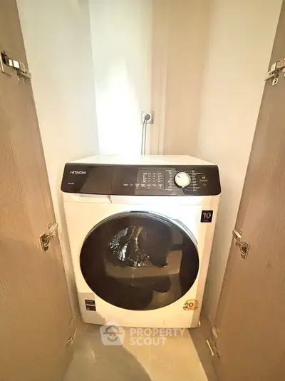 Compact laundry nook with modern washing machine in cozy apartment
