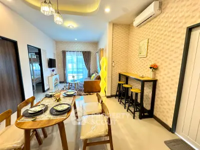 Modern open-plan living and dining area with stylish decor and natural light.