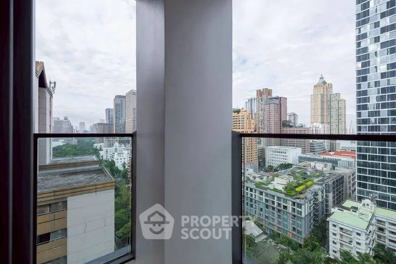 Stunning cityscape view from a high-rise balcony, showcasing urban skyline and lush greenery.