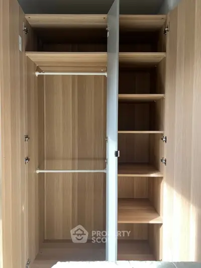 Spacious wooden wardrobe with multiple shelves and hanging rods, perfect for organized storage.