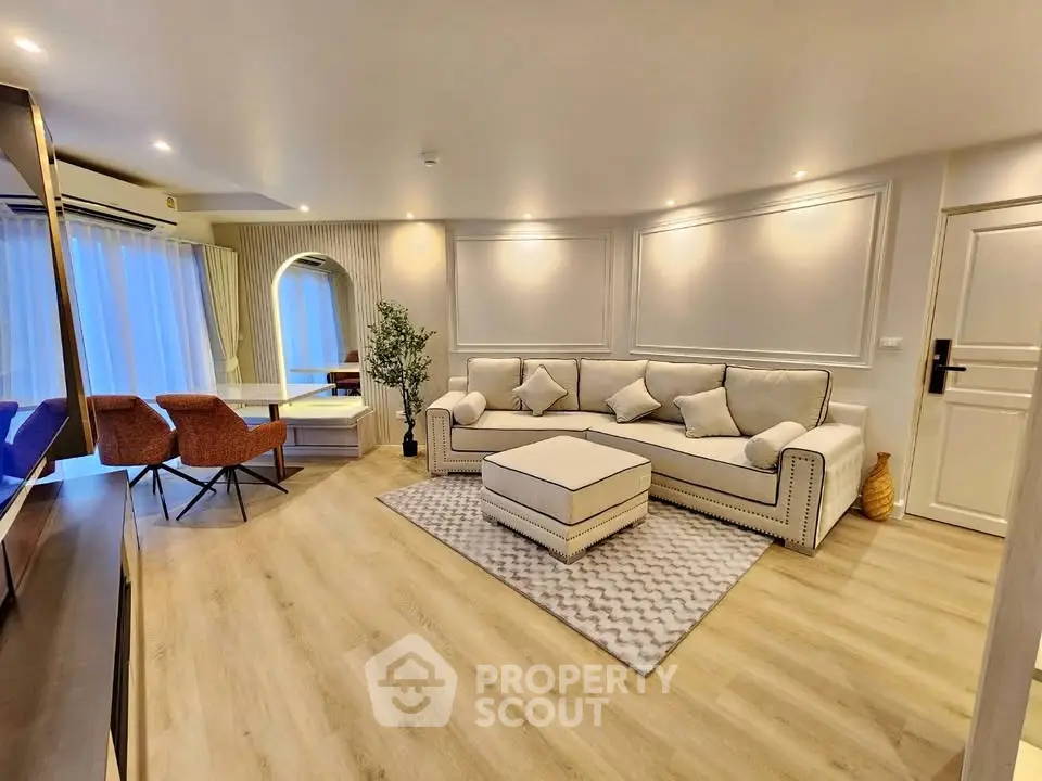 Elegant living room with modern decor, cozy seating, and ambient lighting for a luxurious lifestyle.