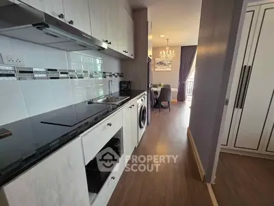 Modern kitchen with sleek cabinetry and integrated appliances in a stylish apartment.