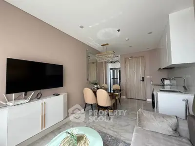 Modern living room with sleek kitchen and dining area, featuring elegant decor and natural light.