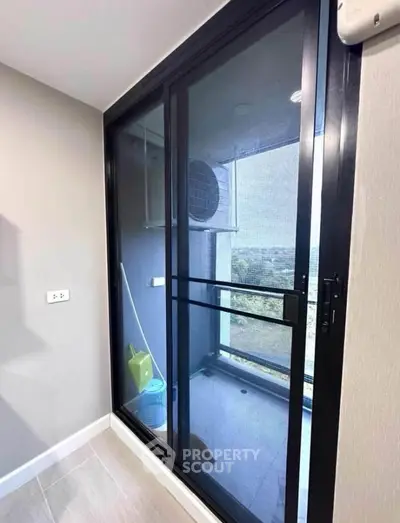 Modern balcony with sliding glass doors and scenic view, perfect for relaxation and enjoying the outdoors.