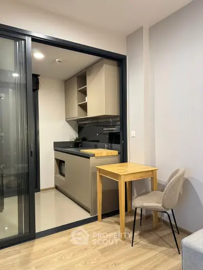 Modern compact kitchen with sleek cabinetry and cozy dining area