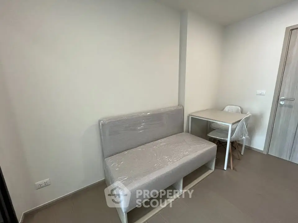 Minimalist small living area with modern furniture and neutral tones