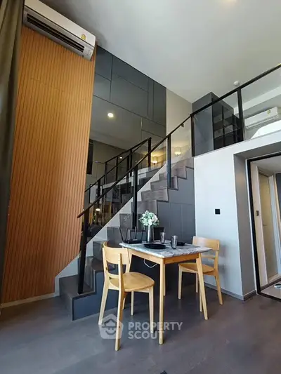 Modern duplex apartment with stylish dining area and staircase