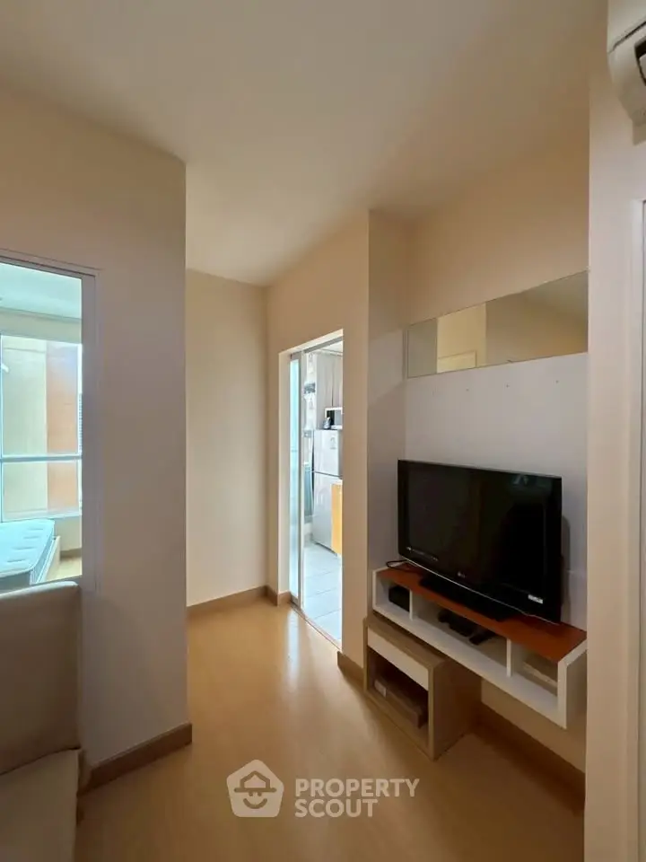 Cozy living room with modern TV setup and natural light