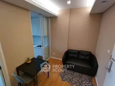 Cozy living room with modern decor and adjacent kitchen area
