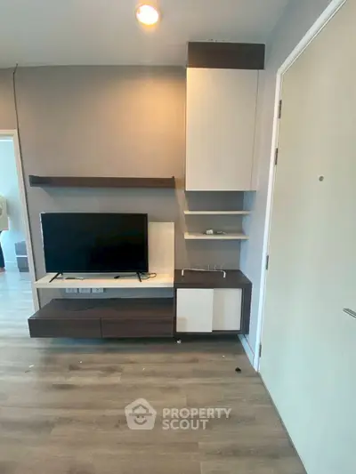 Modern living room with sleek TV unit and stylish wooden flooring