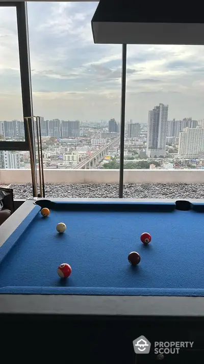 Luxurious rooftop with pool table offering stunning city skyline views