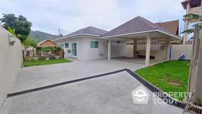 Spacious driveway with covered parking and lush garden in modern home