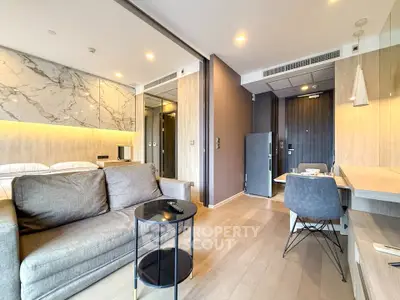 Modern open-plan living room with stylish decor and natural lighting