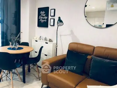 Stylish living room with modern decor, leather sofa, and chic dining area.