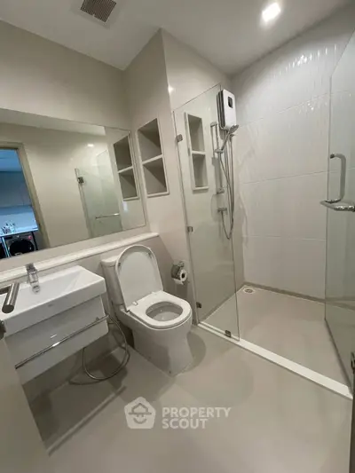 Modern bathroom with glass shower and sleek fixtures