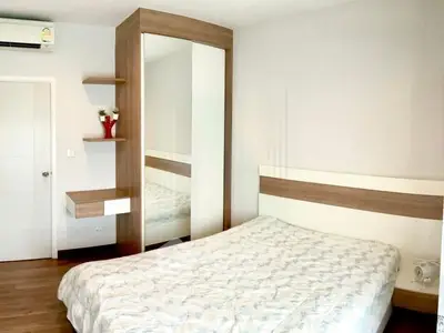 Modern bedroom with stylish wooden furniture and cozy bedding