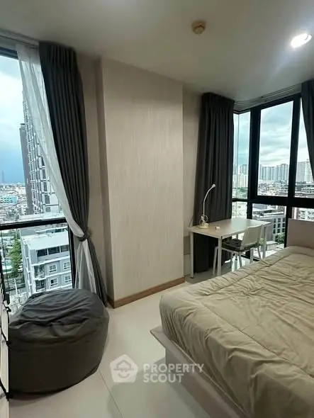 Modern bedroom with city view, featuring large windows and stylish decor.