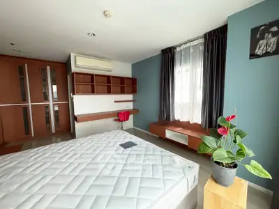 Spacious bedroom with modern decor and natural light