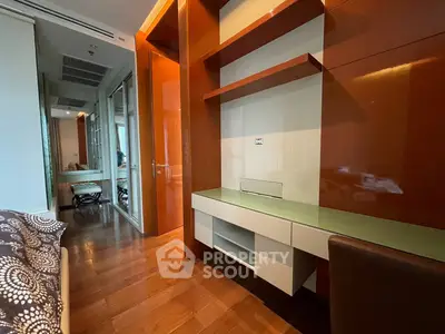 Modern bedroom with built-in desk and wooden flooring