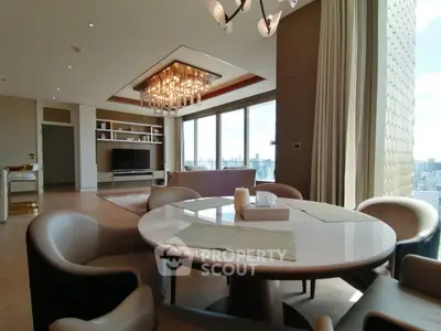 Luxurious modern living room with city view, elegant chandelier, and stylish dining area.