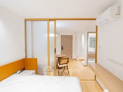 Modern minimalist bedroom with sliding doors and wooden flooring