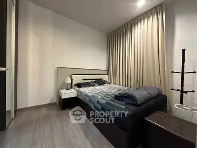 Modern bedroom with sleek design and cozy ambiance, featuring a comfortable bed and stylish decor.