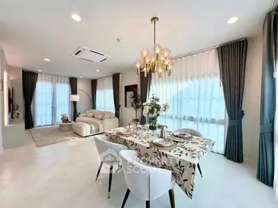 Luxurious open-plan living and dining area with elegant decor and ample natural light.