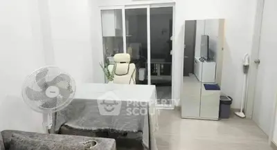 Modern living room with sleek furniture and sliding glass doors in a stylish apartment.