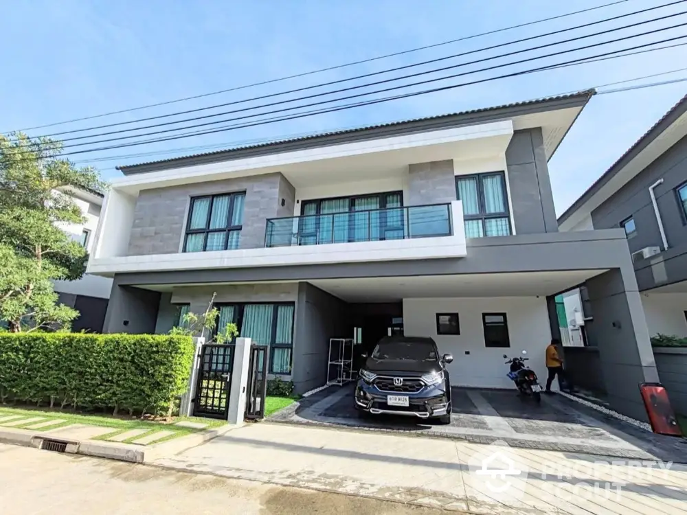 Modern two-story house with sleek design and spacious driveway