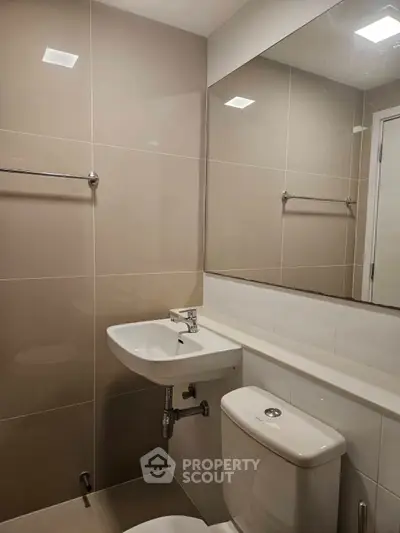 Modern bathroom with sleek fixtures and neutral tiles