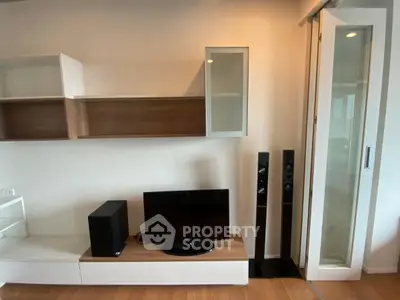Modern living room with sleek entertainment center and stylish shelving.