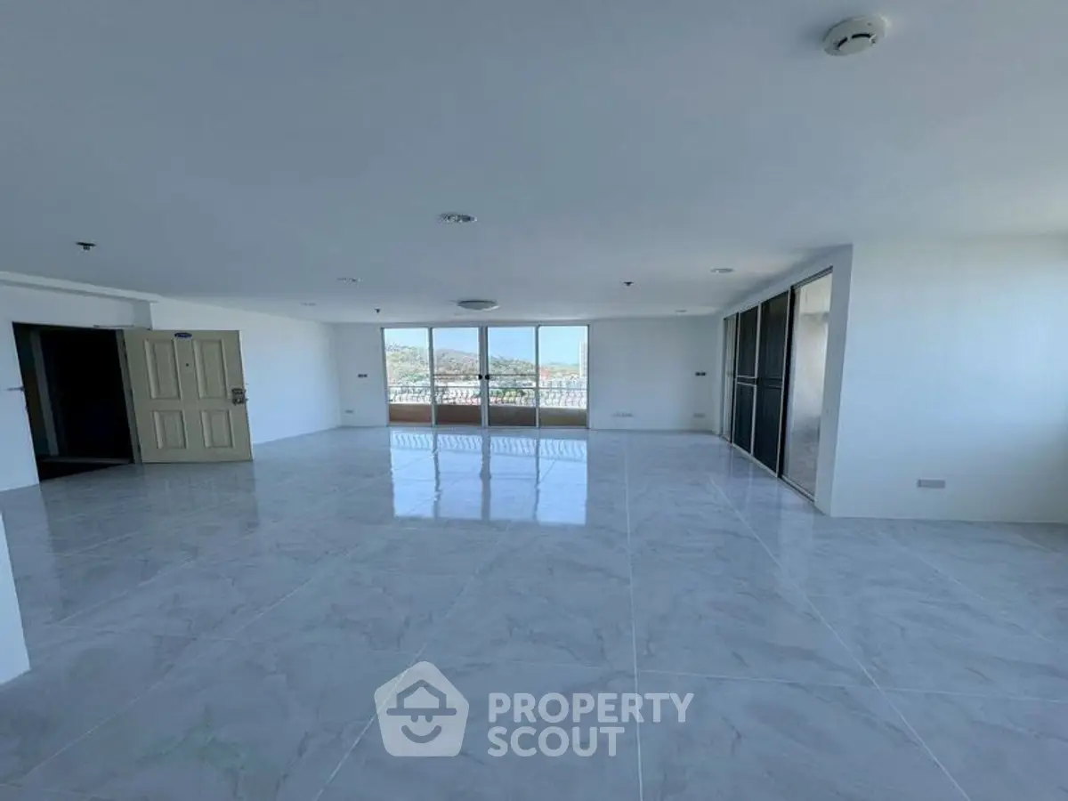 Spacious open-plan living area with large windows offering stunning views, perfect for modern living.